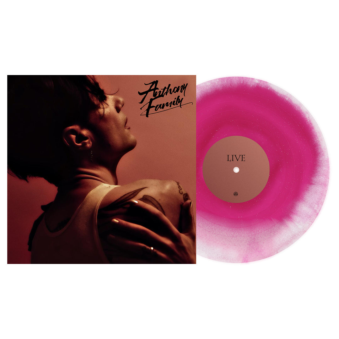 A pink and white marbled Live From An Ordinary Place vinyl by Anthony Family, labeled LIVE, is next to an album cover featuring a tattooed person in a white tank top, turned away, with Anthony Franch scripted at the top right.