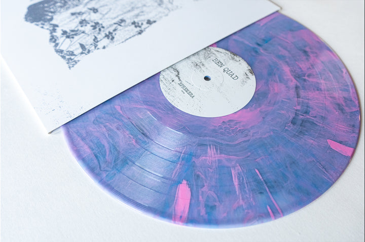 A limited edition Ben Quad vinyl with a marbled purple and pink design peeks from a white cover with black artwork, resting on a white surface. Presale available now; official release date is October 25, 2024.