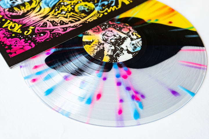 A vibrant Neon Purple Vinyl by Dead Formats, with blue, pink, and purple splashes on clear base, partially pulled from its psychedelic astronaut cover. October 2024 release.