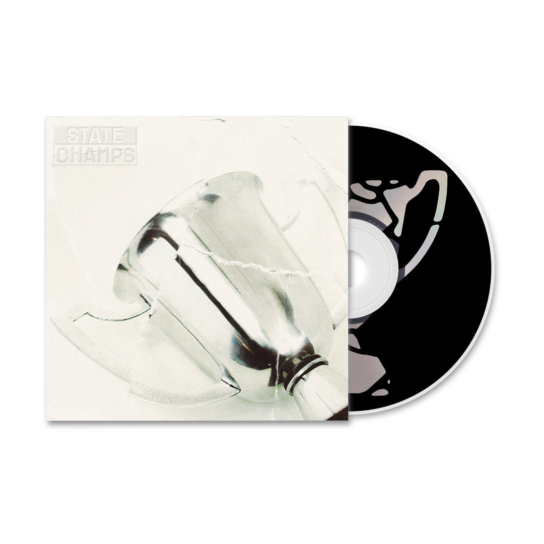 A CD partially out of its case displays “STATE CHAMPS” embossed on a metallic trophy against a white cover, marking the Golden Years album by State Champs releasing in November 2024. The disc features a black and white design.