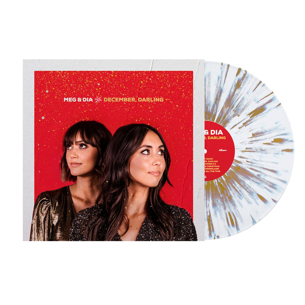 This limited edition Meg and Dia LP features a white and blue splatter vinyl partially inside its festive cover, showing the duo against a red background with gold speckles.