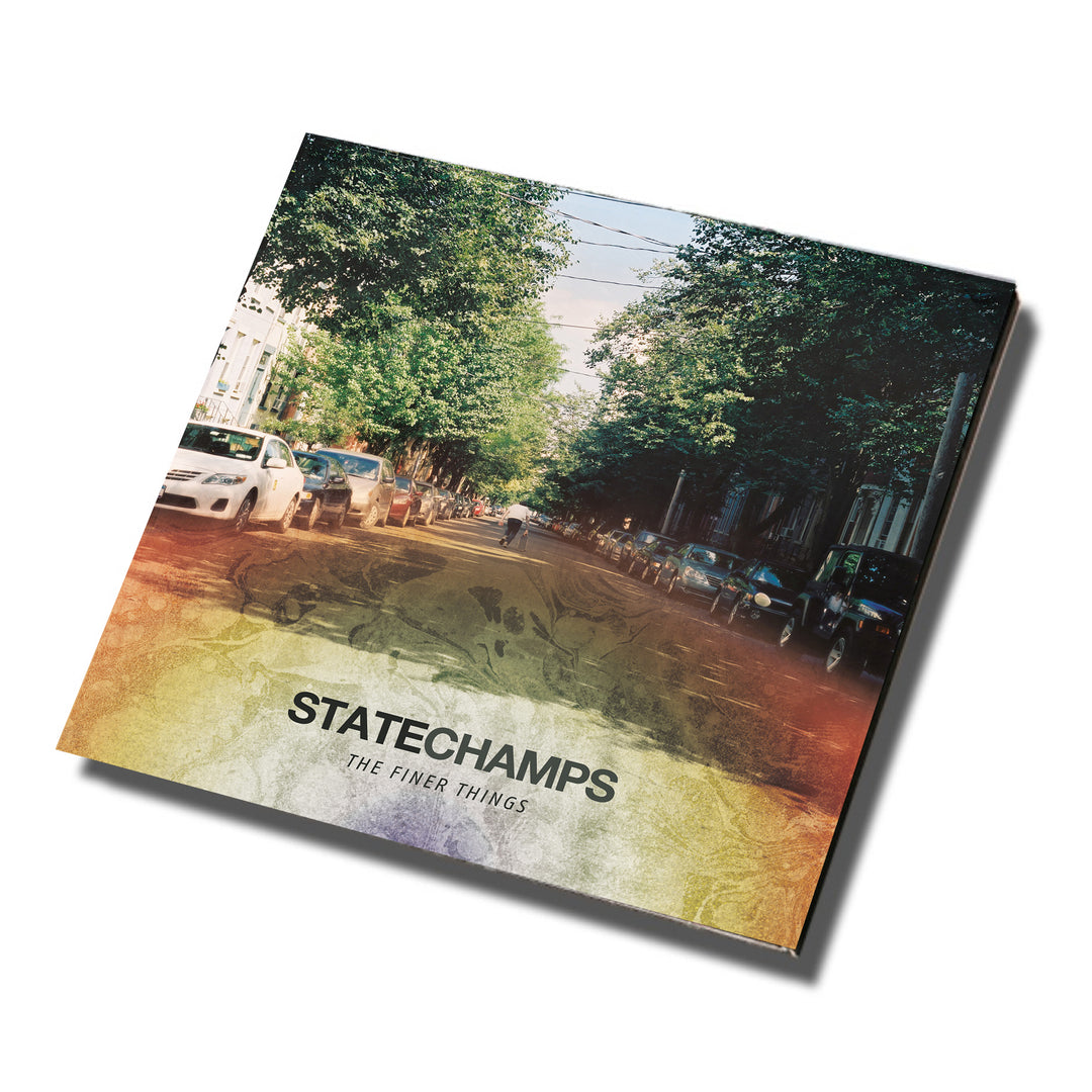 Album cover for “The Finer Things” by State Champs features a tree-lined street, parked cars, and an earthy gradient. The brand name and album title appear in black text, reflecting the essence of tracks found on the CD.