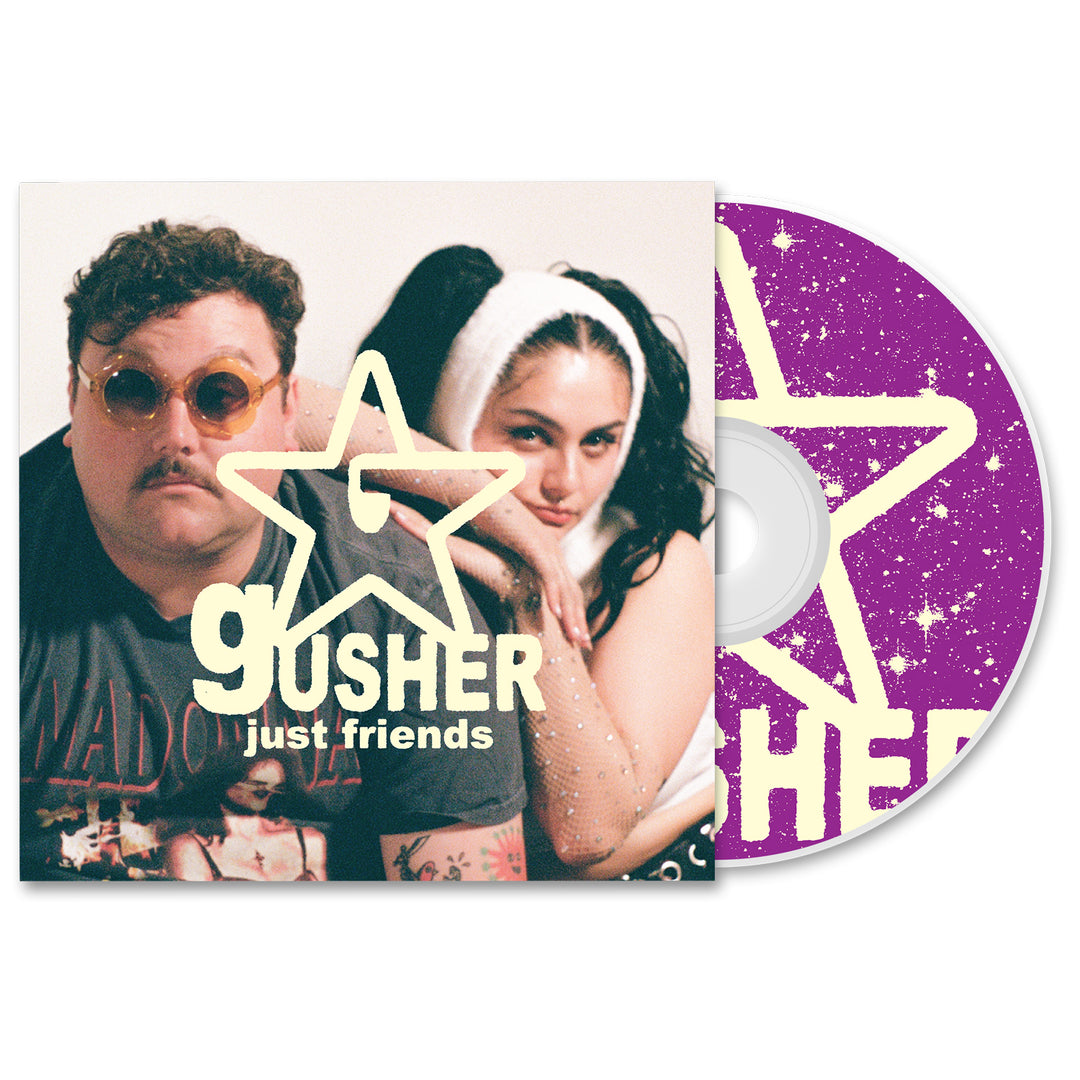 Just Friends Gusher CD. album art depicts two of the band members looking directly at you. one is wearing flower sunglasses and the other a weird hat. CD is exposed to show art on disc. disc art is purple background with small stars and one large star which resembles an uppercase G which is the albums logo.