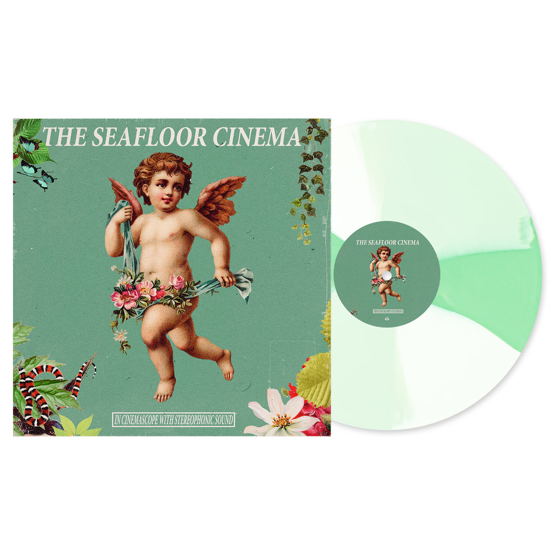 The Seafloor Cinema’s In Cinemascope with Stereophonic Sound album cover shows a cherub and flowers on teal, with plants, and includes a Doublemint Bone White Twist LP featuring a matching marbled center label.