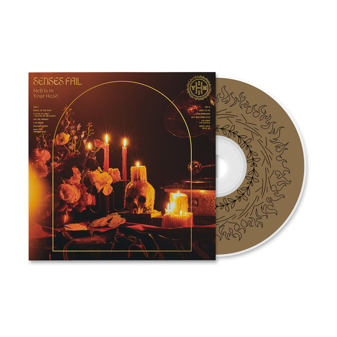 Senses Fail’s “Hell Is In Your Head” CD features a gold disc with black ornate art and track list. The moody album cover displays flowers, candles, a skull, and books softly lit, capturing the powerful vibe of this release.