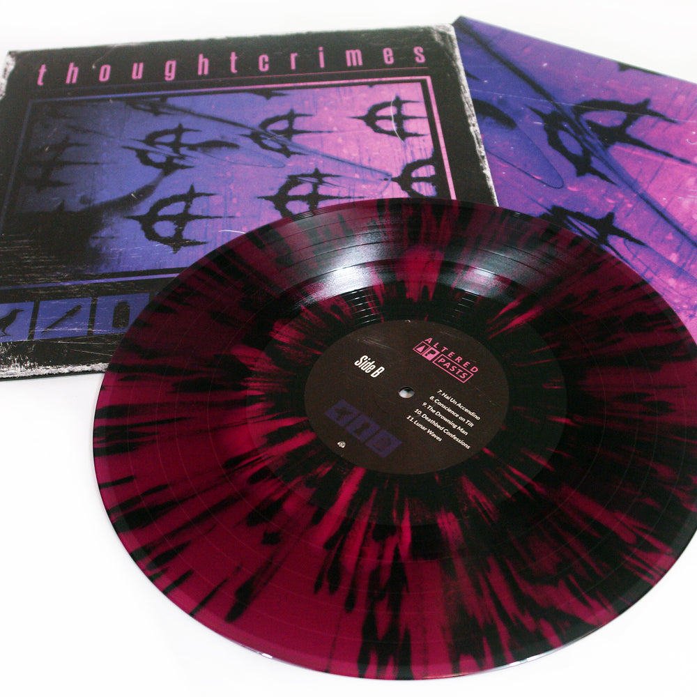 A maroon and black splatter Vinyl LP from thoughtcrimes is shown before its album cover, which features a hot pink on deep purple abstract design with the word thoughtcrimes at the top; the label displays text and track listings.