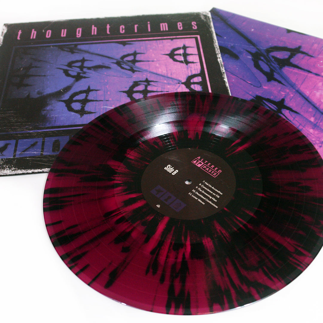 A maroon and black splatter Vinyl LP from thoughtcrimes is shown before its album cover, which features a hot pink on deep purple abstract design with the word thoughtcrimes at the top; the label displays text and track listings.
