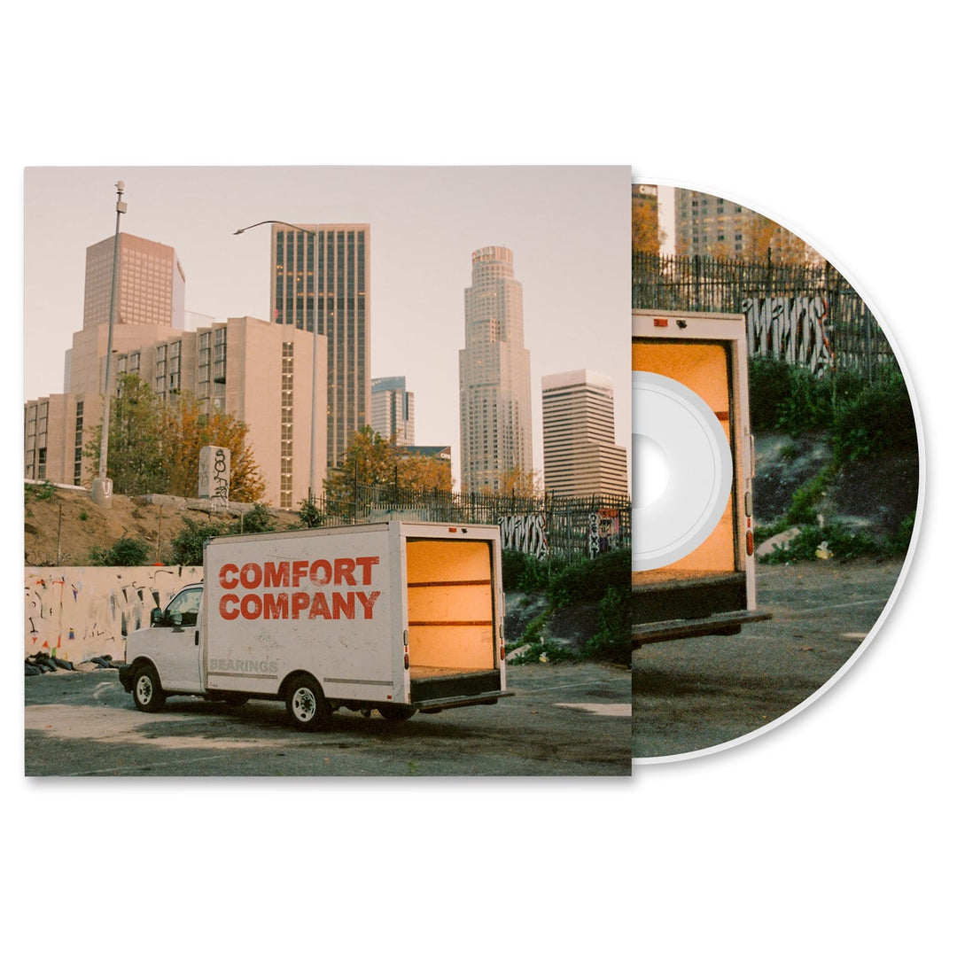 A Bearings CD partially slides out from its case, revealing a van labeled BEARINGS parked near graffiti-covered walls with city buildings behind—a snapshot of the album presale atmosphere.