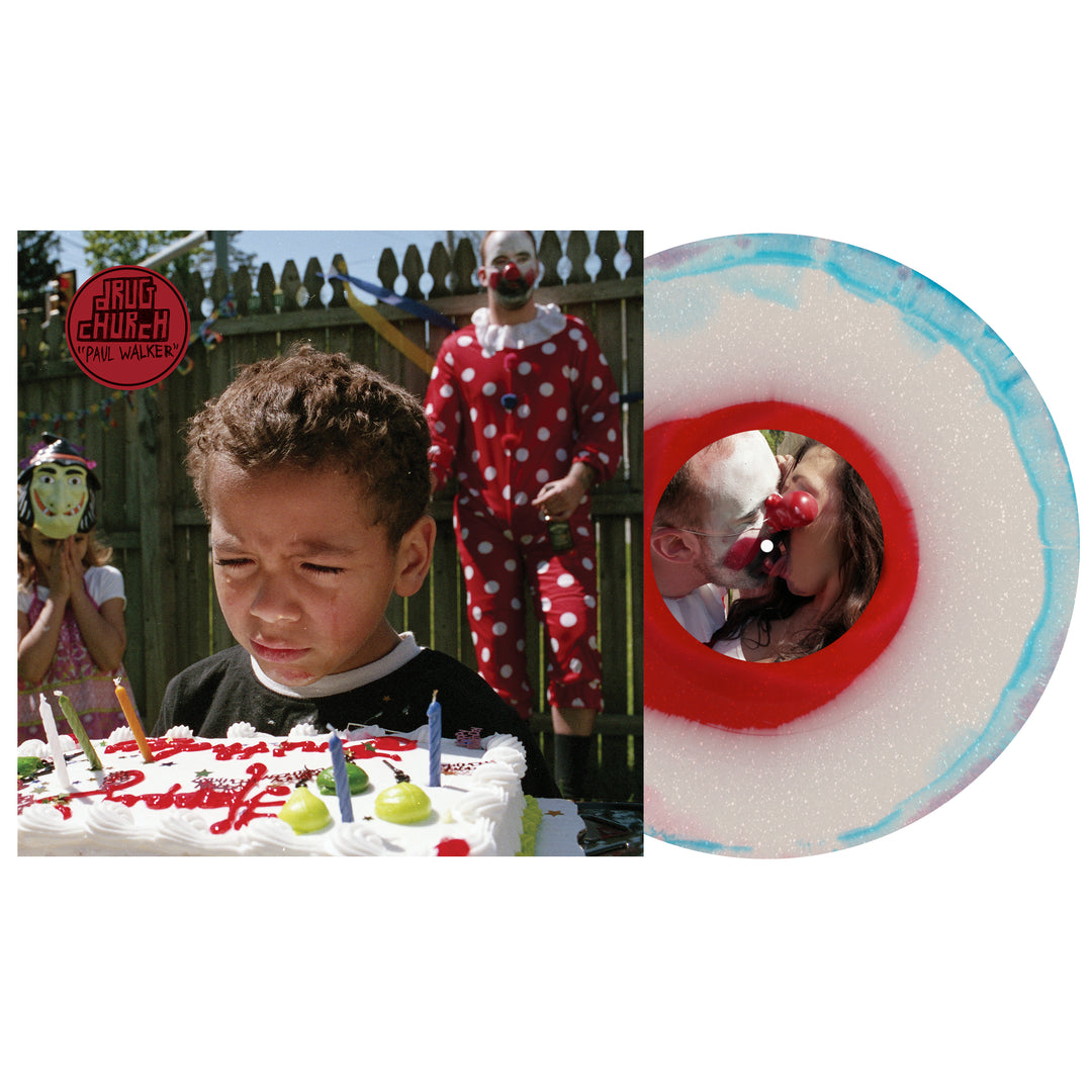 A boy stands upset before a birthday cake outdoors, watched by masked kids and a red clown, as seen on the Drug Church Glitter Vinyl LP cover beside the white and blue splatter vinyl.