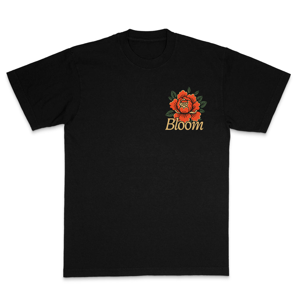 Bloom black t-shirt with a red and orange flower, green leaves, and Bloom in script on the left chest—add a touch of Rose Black elegance to your style.