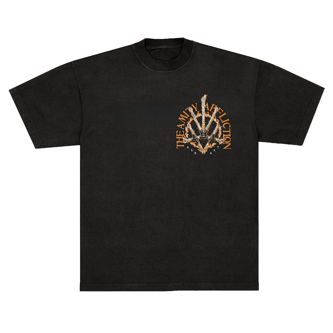 Black The Amity Affliction t-shirt featuring a stylized spiked graphic and orange distressed band text in a circular pattern on the upper left chest.