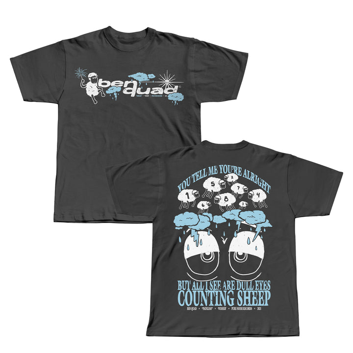 Front and back of a dark grey Ben Quad T-shirt. The front shows Bear Quad with a cartoon bear, stars, and blue clouds; the back features Sheep Pepper among sheep with numbers and the phrase: You tell me you’re alright but all I see are dull eyes counting sheep.