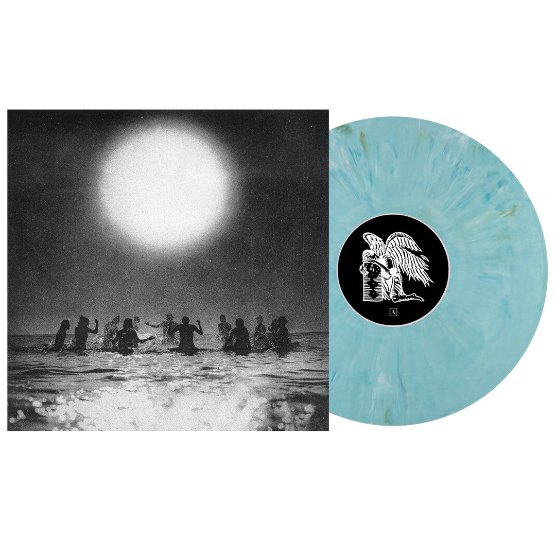 A Seahaven vinyl with a light blue marbled design rests beside its album cover, featuring silhouetted figures in water beneath a bright sun—a bold black-and-white image from the Seahaven collection.