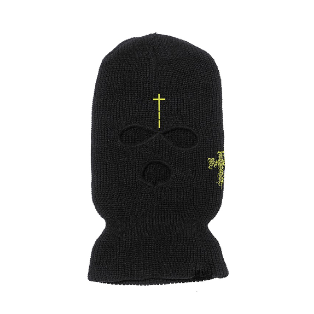 The Knocked Loose black ski mask features three holes for eyes and mouth, a yellow cross above the eyes, and yellow embroidered detail on the right side—combining bold style with classic functionality.