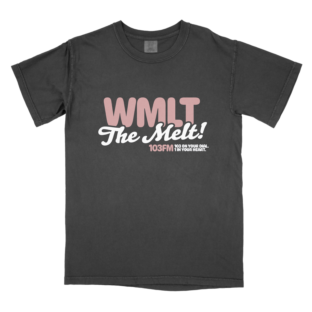A black Alex Melton Heavy T-shirt featuring "WMLT The Melt! 103FM 103 on your dial, in your heart." in bold pink and white retro-style lettering printed on the front.