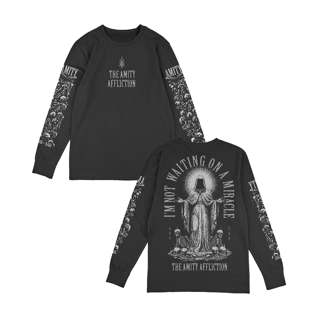Two black long-sleeve shirts by The Amity Affliction feature the band name on the front, a hooded figure with candles and “I’M NOT WAITING ON A MIRACLE.” on the back, plus intricate white floral designs down both sleeves.