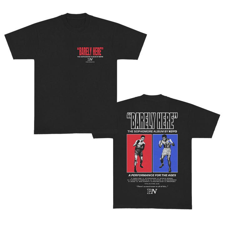 KOYO black t-shirt with "Barely Here" in red on the front. Back features two boxers—one red, one blue—styled like men's underwear, plus text promoting KOYO's sophomore album "Barely Here.