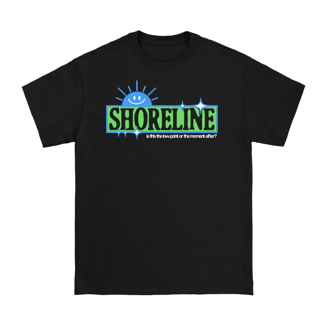 A Shoreline Black T-shirt with a blue smiling sun above "SHORELINE" in bold green-black letters, plus the phrase: Is this the low part or the mount after?.