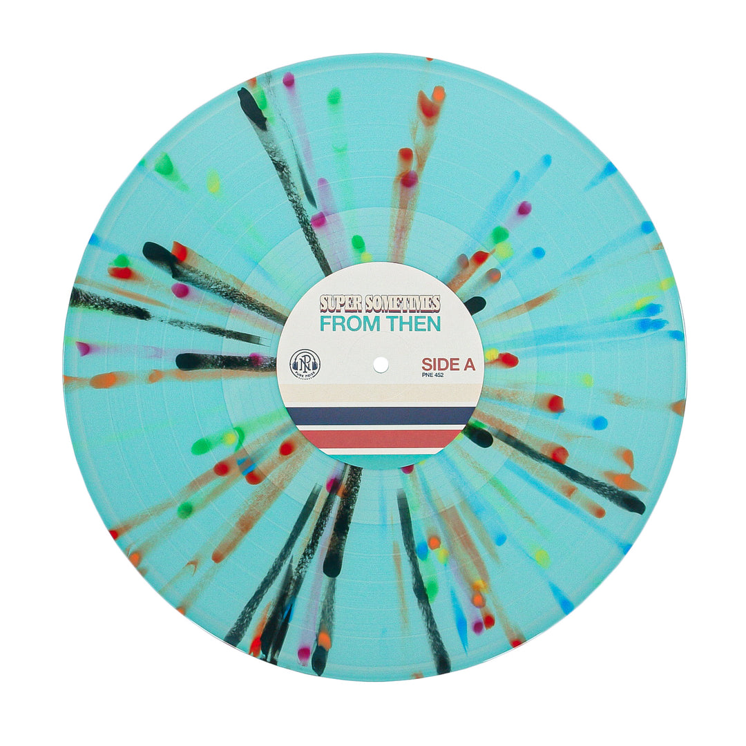 A light blue vinyl record by Super Sometimes with rainbow splatter radiating from the center. The label says SUPER SOMETIMES FROM THEN & NOW SIDE A, with red, blue, and beige stripes underneath.