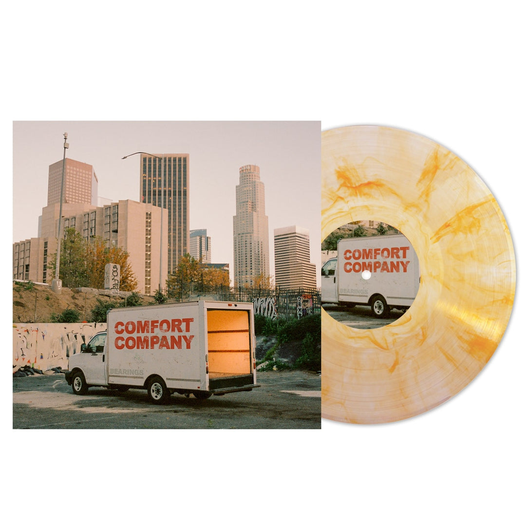 A Bearings Deluxe Marble Vinyl record and its cover. The cover shows a Comfort Company moving truck in front of city buildings at sunset, with graffiti on a wall—a must-have Indie Vinyl for collectors.