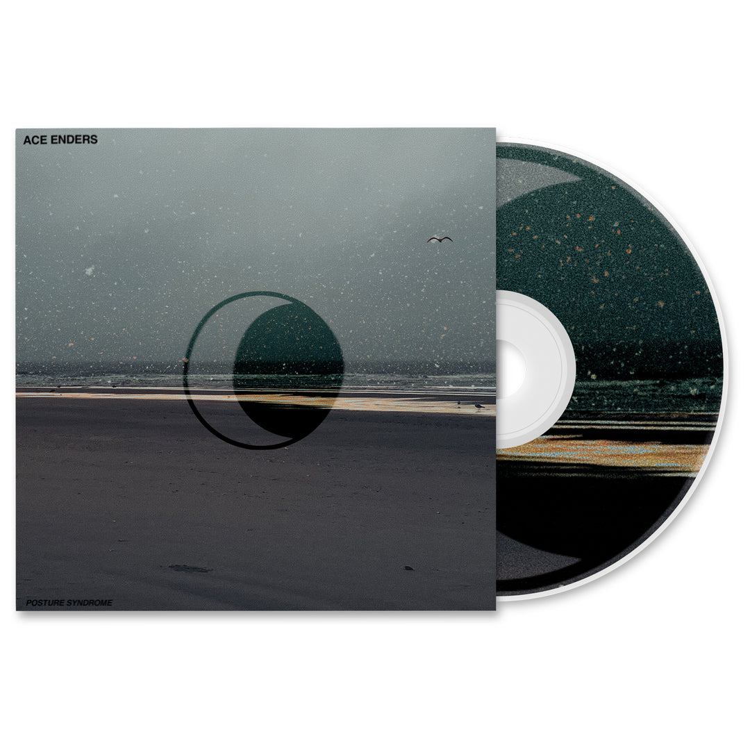 A CD partially in its case shows the Ace Enders album cover: a minimalist dark beach, large transparent crescent, distant bird, and Ace Enders’ name at the top left. The CD design matches the evocative scene.