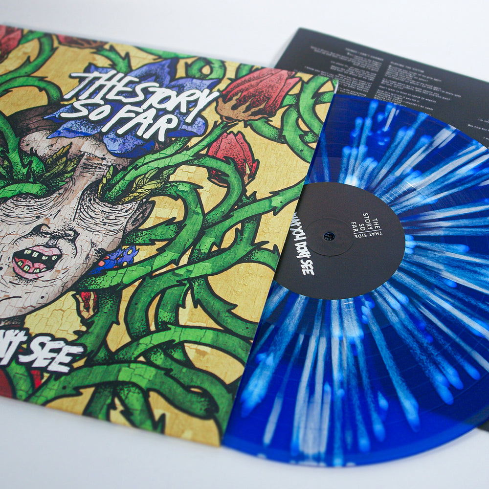 A Royal Blue and white splatter vinyl from The Story So Far peeks out of its album cover, which displays colorful face art with green vines. A lyric insert is also visible.