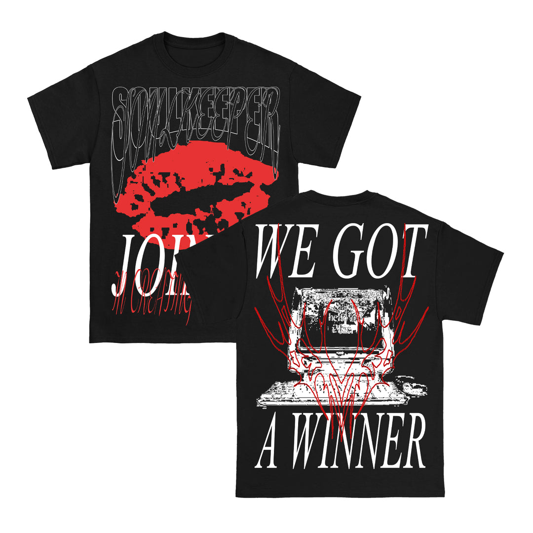 Two black Soulkeeper heavy cotton t-shirts feature striking prints: the front has bold red lips and distorted SOULKEEPER JOIN text, while the back reads WE GOT A WINNER above a stylized skull and red abstract graphic. Classic Gildan Heavy style.