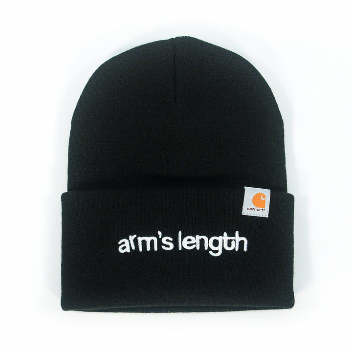 A black Arm's Length beanie with "arms length" embroidered in white lowercase on the front fold and a small Carhartt logo tag on the right—a classic choice for fans of embroidered beanies.