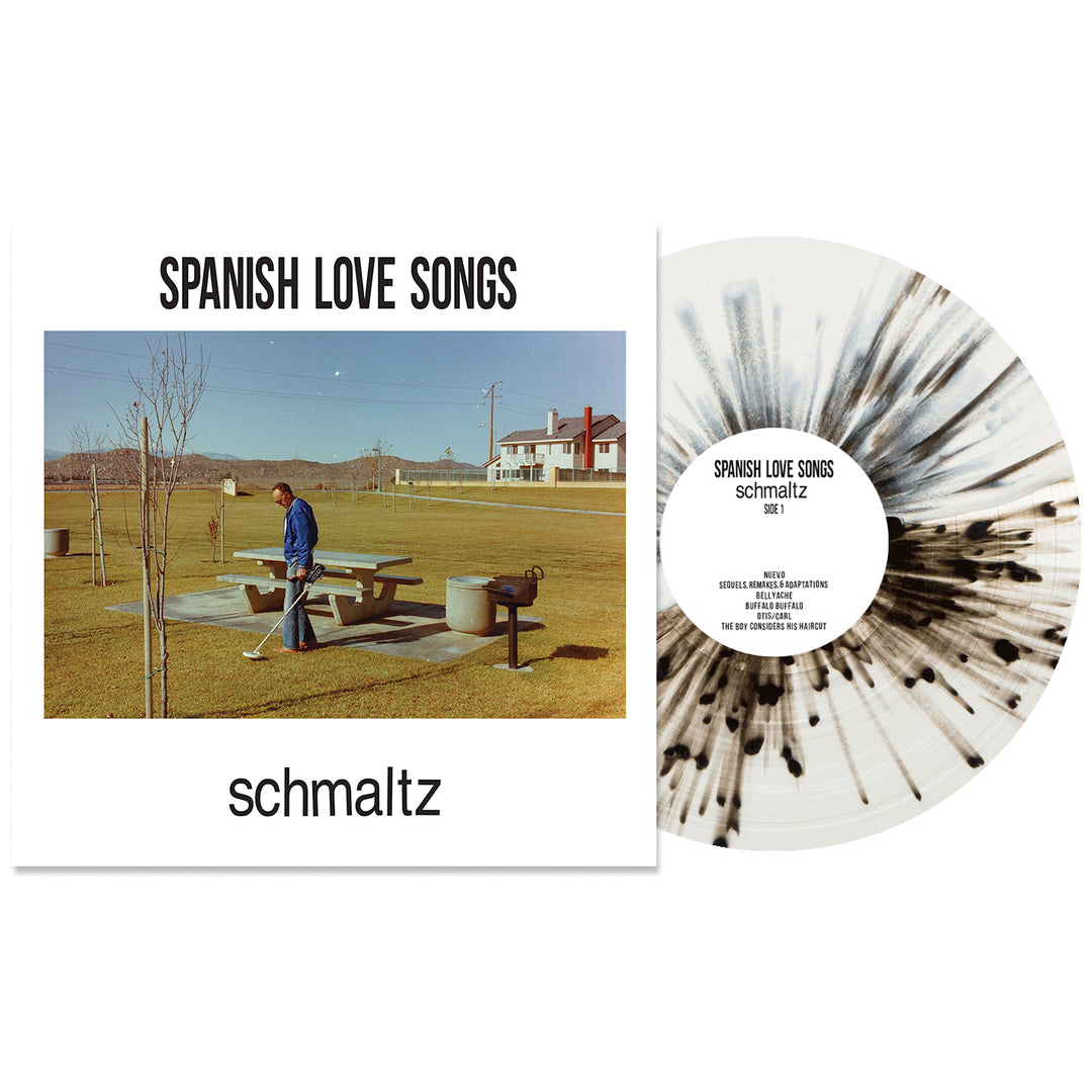 The Spanish Love Songs Schmaltz vinyl LP features a man at a picnic table in a grassy park. The presale bundle includes a white splatter vinyl with black patterns. Album and band names appear in bold black text on the cover.