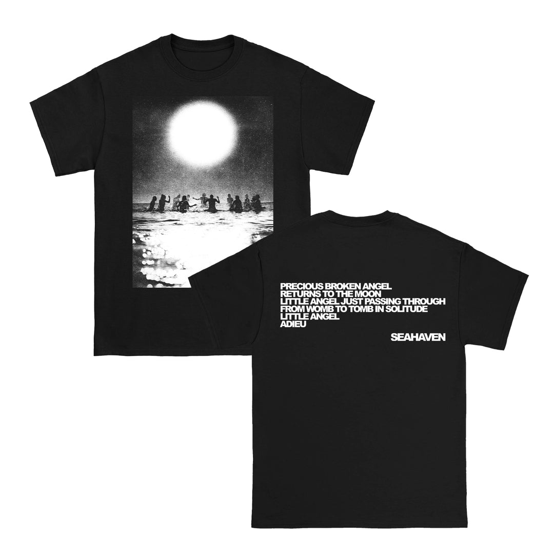 Seahaven black cotton t-shirt with a front graphic of silhouetted figures in water under a bright sun; back features white song lyrics ending with SEAHAVEN. Perfect for printed tee lovers.