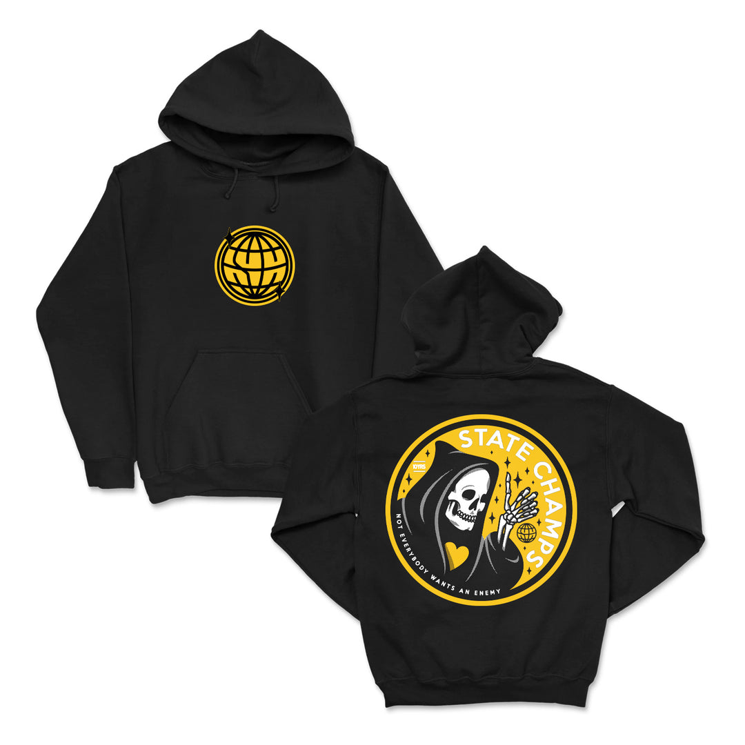 State Champs black hoodie with a yellow globe logo on the front and a large back graphic showing a hooded skeleton, flowers, and “STATE CHAMPS” text in yellow and white.