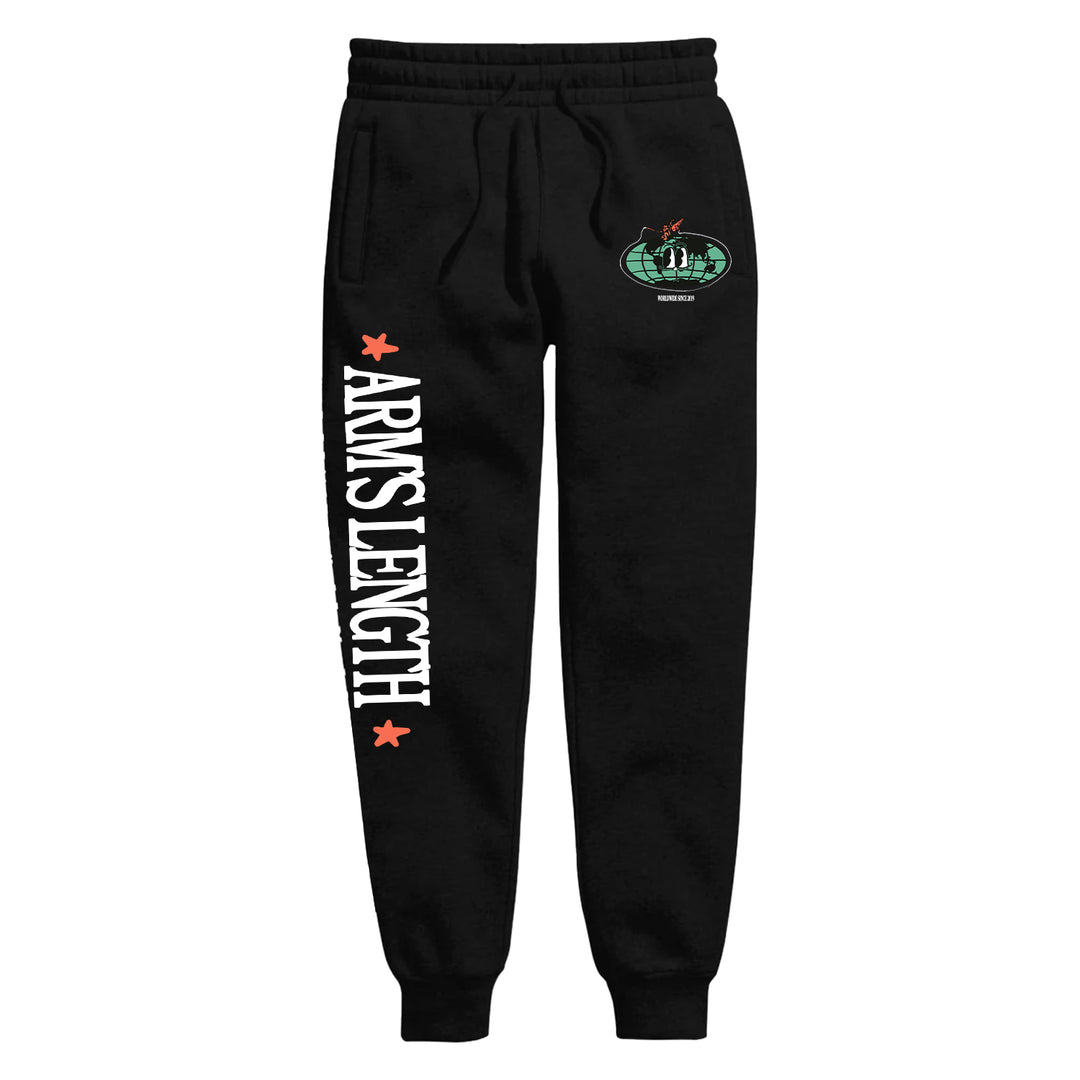 Black jogger sweatpants by Arm's Length feature "ARMS LENGTH" in bold white letters down the left leg, accented with red stars and a small green-and-red patch near the pocket.
