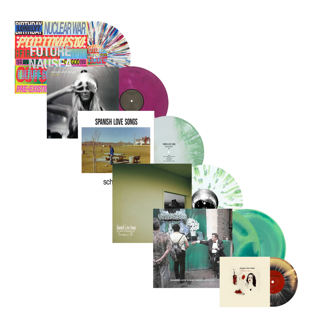 Six colorful limited edition records, each partially covering the one behind it. Each record features unique cover art and vibrant colored vinyl, arranged in a diagonal pattern on a white background.