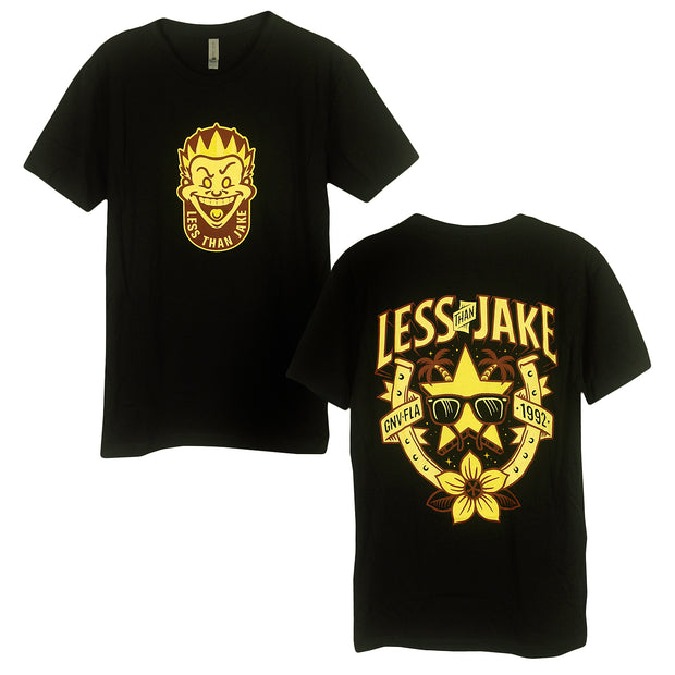 image of the front and back of a black tee shirt. front on the left has a small center chest print in yellow and brown of a spikey haired male face. arched up at the bottom says less than jake. back on the right has full back print that says less than jake. star with sunglasses, horseshoe , palm trees and flowers below.