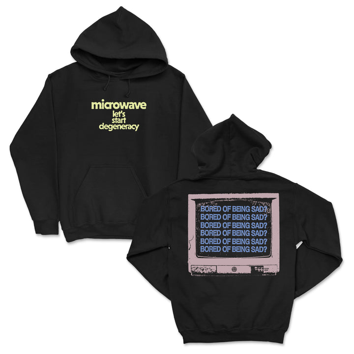 Black hoodie by Microwave with “microwave lets start degeneracy” in yellow on the front. The back features a pink TV and repeated blue “BORED OF BEING SAD?” text, creating standout custom apparel.