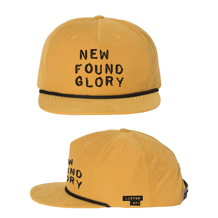 A mustard yellow New Found Glory baseball cap with black "NEW FOUND GLORY" embroidery on the front, a black cord above the brim, and a small LISTEN UP! tag on the side. Shown from front and side views.