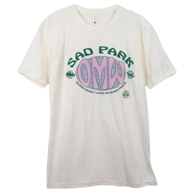 image of a natural colored tee shirt on a white background. front and center print that says sad parl O M W everybody I love is back home