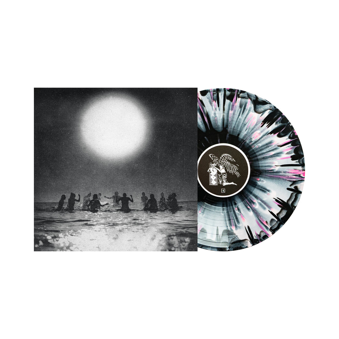 A vinyl pressing of the 2026 Seahaven album with a black, white, and pink splatter design is partly pulled from its cover, which shows people in water under a bright sun—a distinctive release from the Seahaven brand.