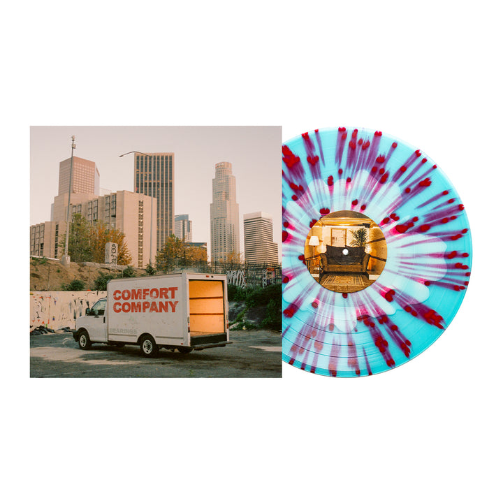 Album cover for Bearings shows a moving truck labeled "Comfort Company" parked before city buildings at sunset; next to it, a Bone in Electric Blue vinyl LP with pink and purple splatters and a cozy room scene on the center label.