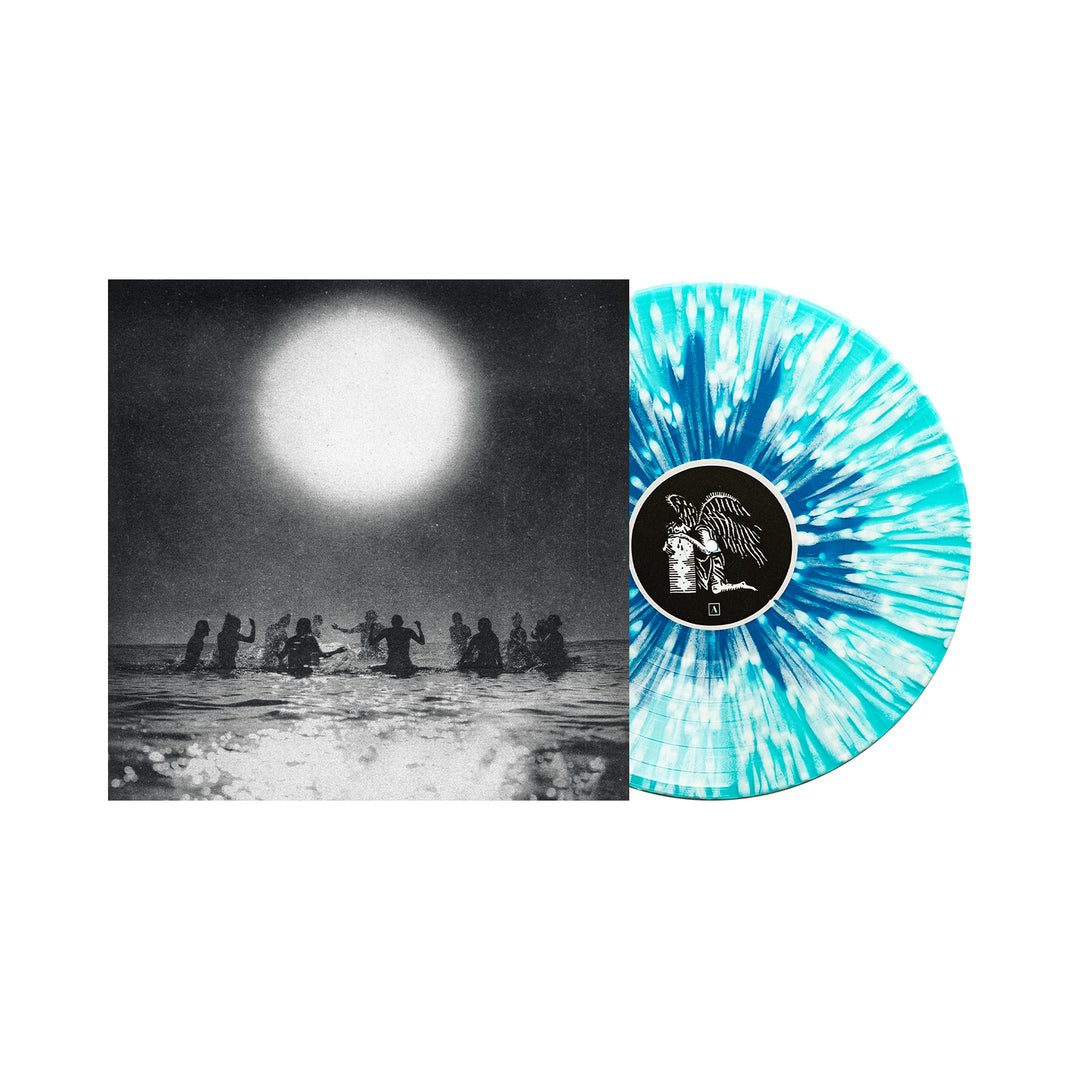 A Seahaven vinyl album with a blue and white splatter design is shown partly out of its cover, which displays a black and white photo of people standing in water under a large sun.