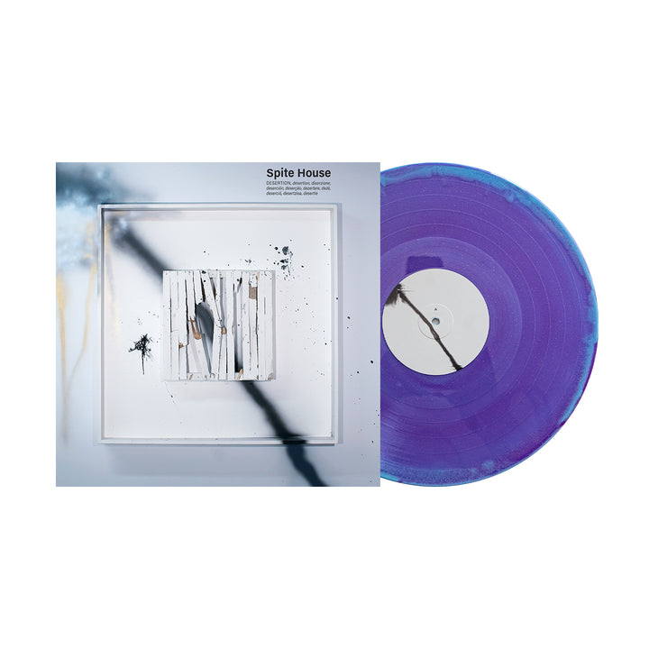A Desertion Violet & Baby Blue Glitter Vinyl LP from Spite House rests by its abstract album cover, which displays white sticks and shadowy forms on frosted tones. Album releases September 16, 2025.