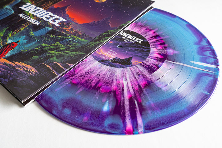 A vibrant Unwell Allegoria vinyl with purple, blue, and white swirls peeks out from its fantasy-themed cover, showcasing an otherworldly landscape—an ideal addition to any colored splatter LP collection or album presale.