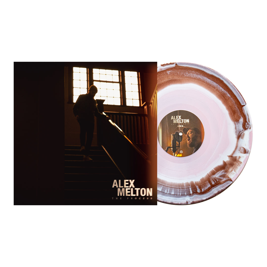 A marbled white and brown vinyl LP by Alex Melton is displayed next to its album cover, which shows a silhouetted figure on a staircase near a window with the text "Alex Melton - The Process".