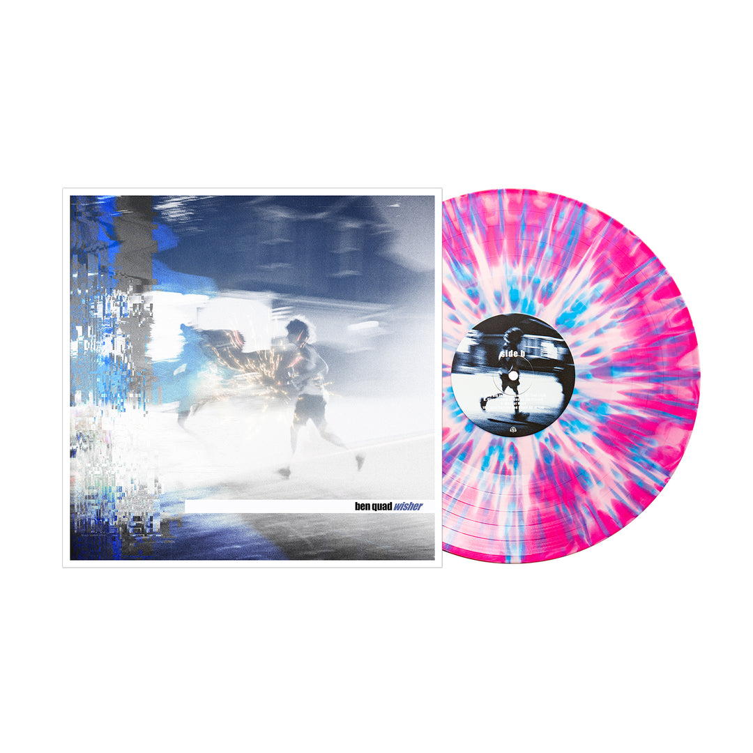 A baby pink splatter LP in blue and white, from Ben Quad’s Wisher album, sits beside a cover depicting a blurred figure running through a cool-toned urban scene. Secure your vinyl during the presale.