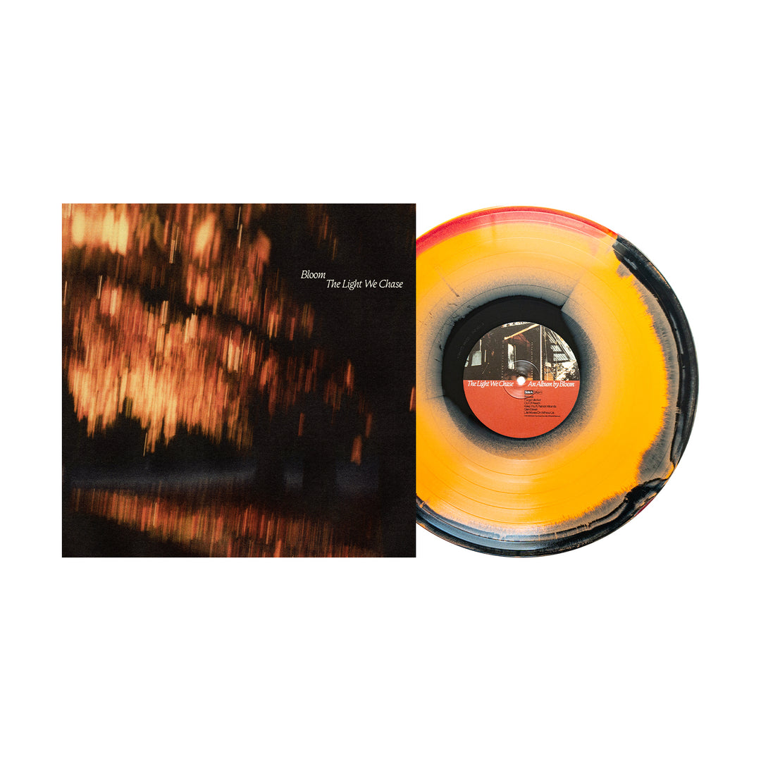 The limited edition "The Light We Chase" vinyl by Bloom features an orange, yellow, and black swirl record beside its cover of blurred warm lights. Both the artist Bloom's name and album title are displayed on this presale LP.