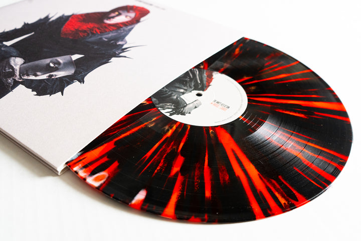 A black The Amity Affliction House Of Cards vinyl with blood red & white splatter slides from an album cover featuring stylized monochrome figures with red accents—an Amity Exclusive design.