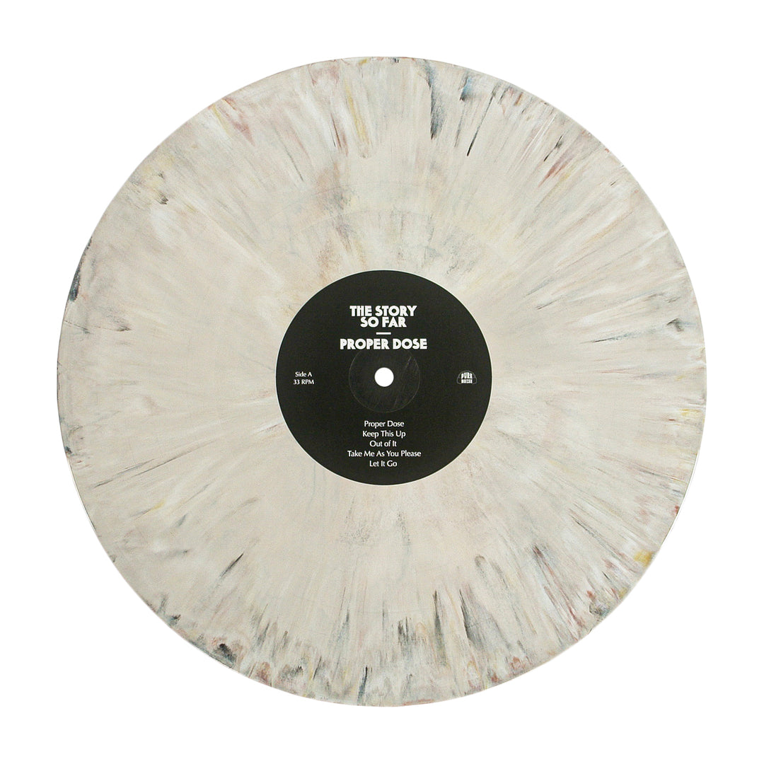 A limited edition vinyl from The Story So Far, featuring white, gray, and beige marbling. The black center label shows "The Story So Far Proper Dose" and the tracklisting in white text.