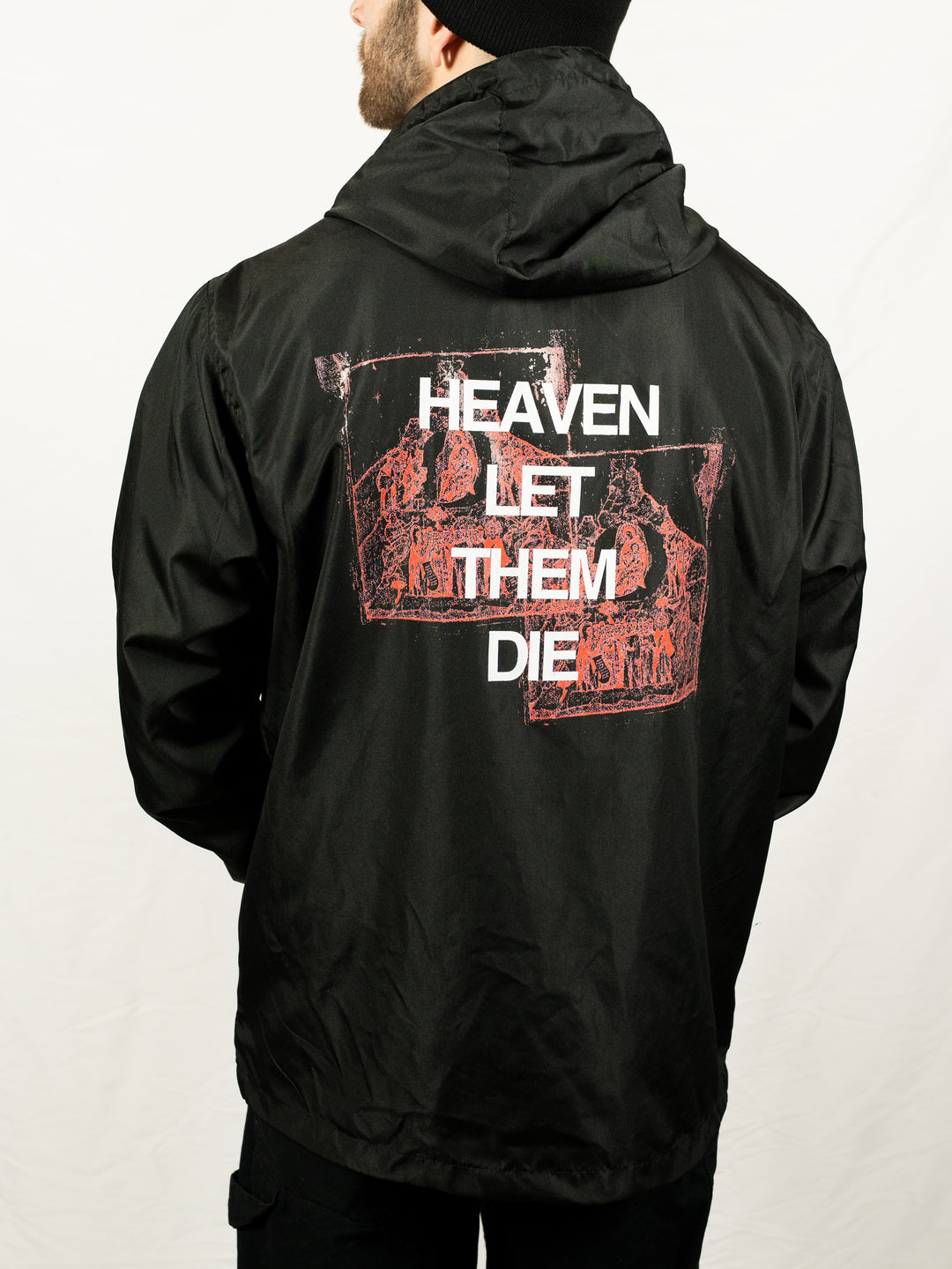 A person wearing a Counterparts black unisex jacket featuring "HEAVEN LET THEM DIE" and red graphic designs on the back, standing against a plain white background.