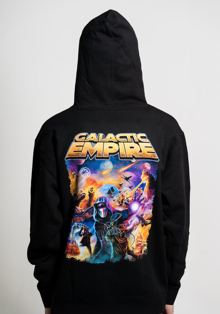 A person in a black Galactic Empire hoodie with the hood up; the back displays vibrant Galactic Empire text and colorful sci-fi artwork of spaceships, planets, and a masked figure with glowing eyes and a weapon.