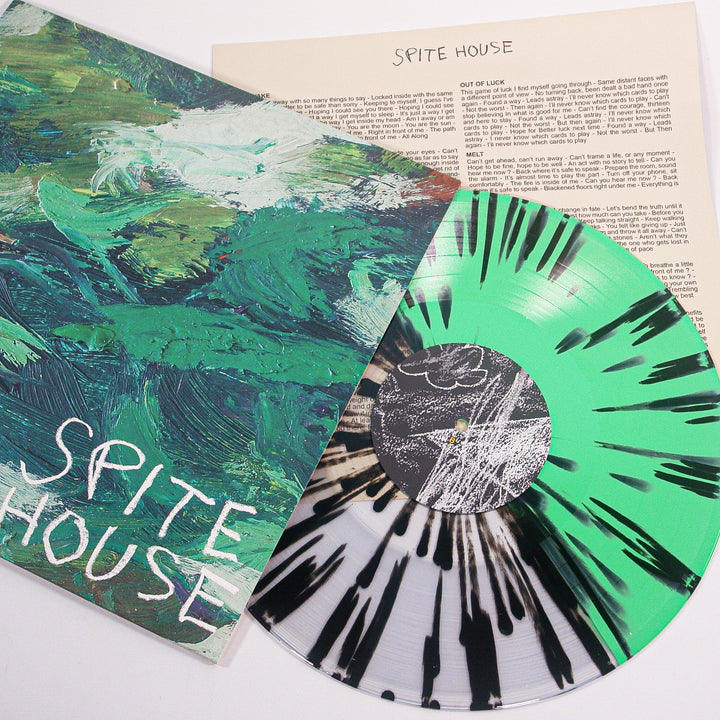 A Spite House Splatter Vinyl LP in green, black, and white rests beside its cover featuring abstract green brushstrokes and Sprite House handwritten below—ideal for any Spite House vinyl collector.